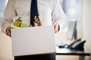 Employee Leaving Office With Belongings Wallpaper