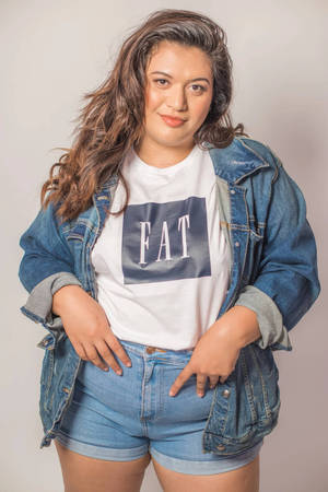 Empowered Plus-size Woman Rocking Denim Style Wallpaper