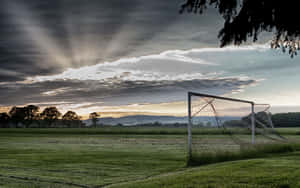 Empty Football Field With Gray Clouds Wallpaper