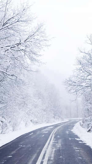 Empty Road In Snow Iphone Wallpaper