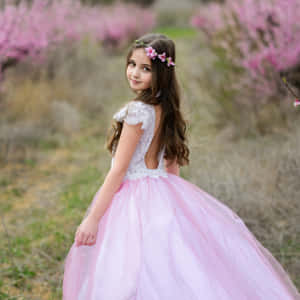 Enchanting Beauty In Pink - A Pretty Girl Adorned In A Princess Dress Wallpaper