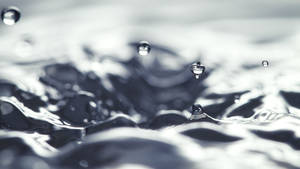 Enchanting Dance Of Water Droplets Wallpaper