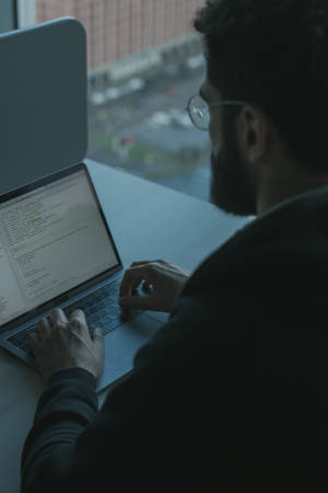 Engineer Typing On A Laptop Wallpaper