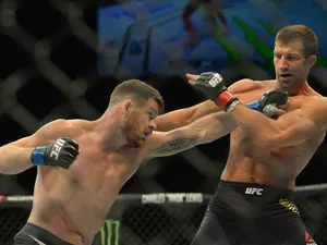 English Ufc Fighter Michael Bisping Strikes Luke Rockhold 2016 Photograph Wallpaper
