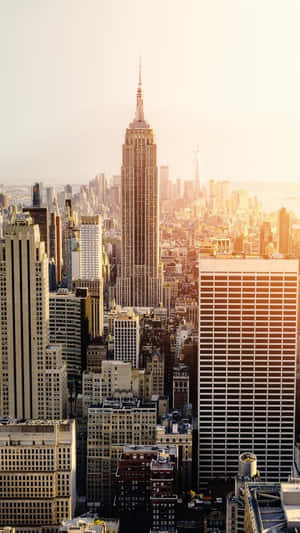 Enjoy A Panoramic View Of The City Skyline During A Spectacular Sunset. Wallpaper