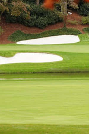 Enjoy A Round Of Golf At The World Famous Augusta National Golf Club Wallpaper