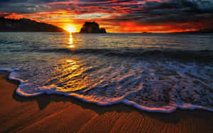 Enjoy The Beauty Of A Beach Sunset Wallpaper