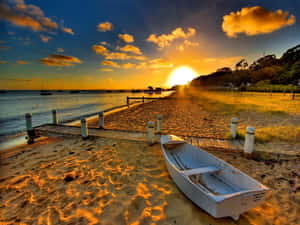 Enjoy The Beauty Of A Sunset At The Beach. Wallpaper