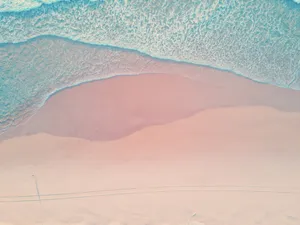 Enjoy The Beauty Of A Tranquil Pastel Beach Wallpaper