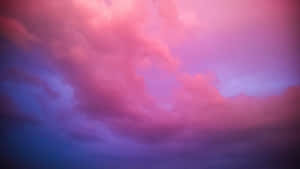 Enjoy The Beauty Of The Sky With Breathtaking Pink And Blue Clouds. Wallpaper