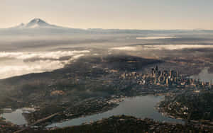 Enjoy The Breathtaking Skyline Of Seattle At Night Wallpaper