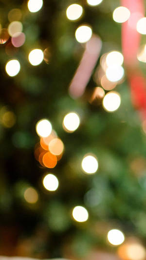 Enjoy The Festive Atmosphere Of Christmas With This Amazing Iphone Wallpaper! Wallpaper