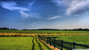 Enjoy The Pastoral Beauty Of A Rural Farm Wallpaper