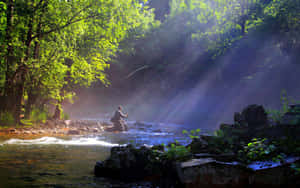 Enjoy The Peacefulness Of The River While Fly Fishing. Wallpaper