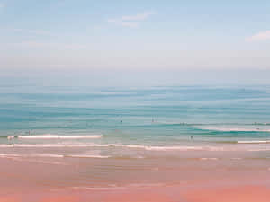 Enjoy The Pink Ocean Horizon For A Peaceful Beach Aesthetic Wallpaper