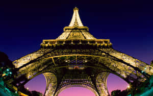 Enjoy The Romantic Lights Of Paris At Night Wallpaper