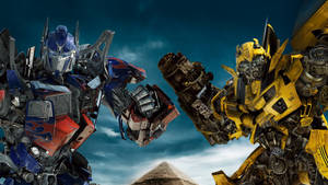 Epic Scene In 4k Ultra Hd Featuring Transformers Heroes Optimus Prime And Bumblebee Wallpaper