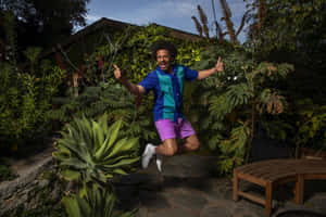 Eric Andre Jumping Garden Thumbs Up Wallpaper