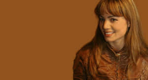 Erica Durance Smilingin Brown Leather Jacket Wallpaper