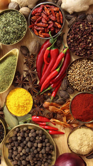 Essential Cooking Spices On Wooden Surface Wallpaper