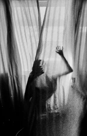 Ethereal Figure Behind Curtains Wallpaper