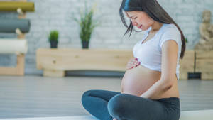 Expectant Mother Embracing Serenity Wallpaper