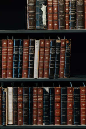 Experience The Thrill Of A Great Read On Your Iphone Wallpaper