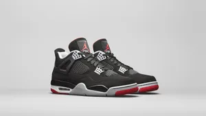 Explore Flight With The Air Jordan 4s Wallpaper