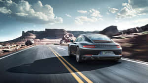 Explore The Road In A Rugged Porsche Wallpaper