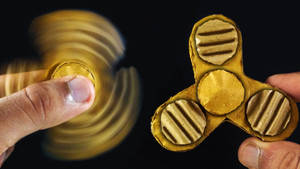 Exquisite Golden Fidget Spinner In Action Wallpaper