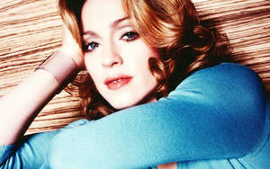 Exquisite Madonna In Blue Top Wallpaper