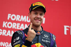 F1 Champion Sebastian Vettel Celebrating Victory Wallpaper