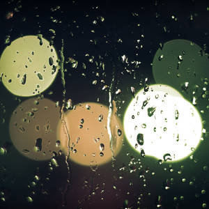 Falling Raindrops With Colorful Light Orbs Wallpaper