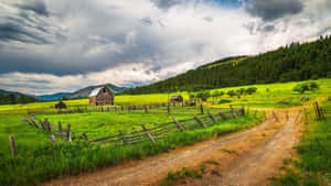 Farmland And Farmhouse In The Countryside Wallpaper
