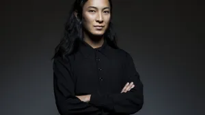 Fashion Designer Alexander Wang Confidently Standing With Arms Crossed Wallpaper
