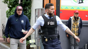 Fbi Agents In Uniform Walk Down The Street Wallpaper