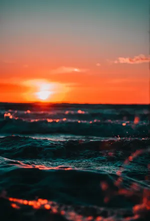 Feel The Ocean Breeze On A Beautiful Sunset Wave Wallpaper