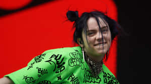 Feel The Thrill Of Music With Billie Eilish And Her Laptop Wallpaper