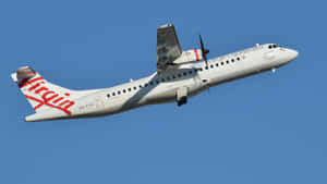 Feel The Thrill Of Soaring Through The Sky In A Passenger Aircraft Wallpaper