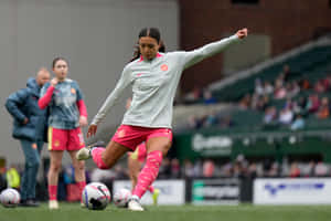 Female Footballer Practicing Ball Control Wallpaper