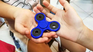 Fidget Toy On Hands Wallpaper