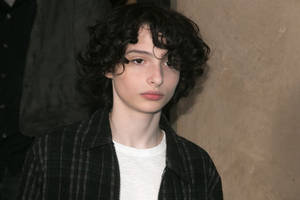 Finn Wolfhard Serious Look Wallpaper