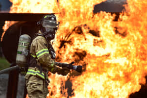 Fire Department Officer In A Huge Fire Wallpaper