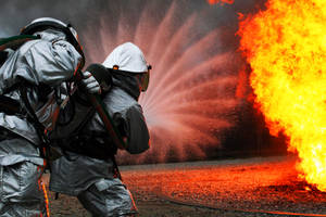 Firefighter Unleashing A Powerful Water Blast Wallpaper