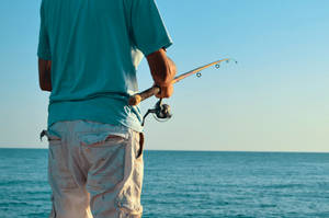 Fishing Man In Blue T-shirt Wallpaper