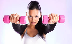 Fit Woman Holding Pink Dumbbells Wallpaper