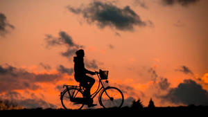 Fitness Cycling At Sunset Wallpaper
