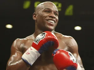 Floyd Mayweather Smiling Red Boxing Gloves Wallpaper