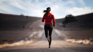 Focus Running Woman In Road Wallpaper