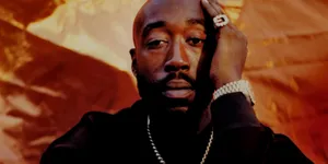 Freddie Gibbs Portrait Orange Backdrop Wallpaper